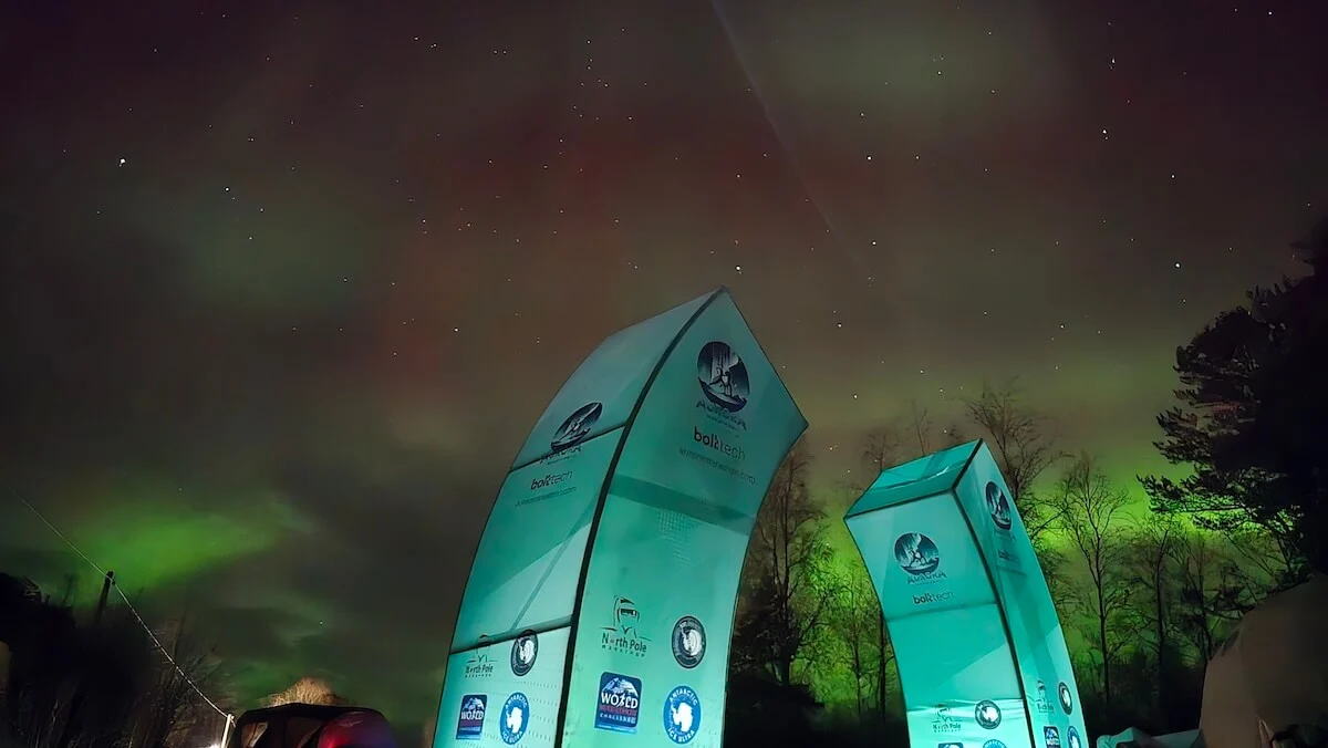 Aurora Marathon race flags beneath the northern lights