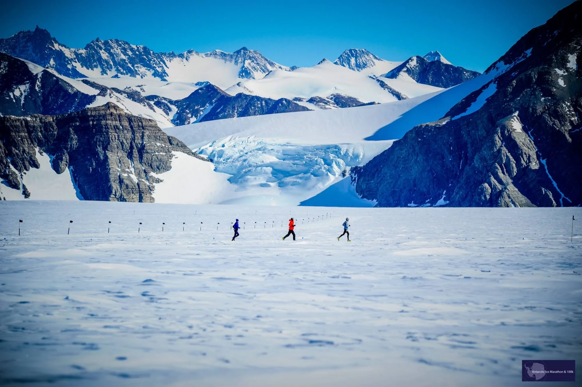 Runners crossing the Antarctic landscape